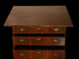 an image of a wooden chest of drawers on a black background