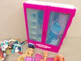 a barbie doll and a barbie doll in a pink case
