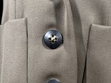 a close up of a coat with buttons on it