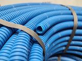 a large pile of blue hoses stacked on top of each other