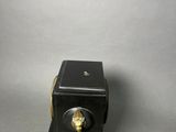 an image of a small black clock with a gold lion head on it