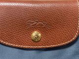 an image of a brown leather purse with a horse on it