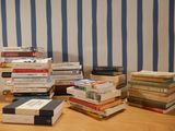 many books stacked on top of each other on a table