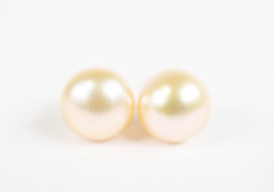 pair of pearl earrings on a white background