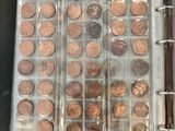 an open book with a bunch of coins in it on a table