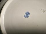 an image of a close up of a white plate with a blue monogram on it