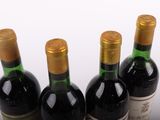 three bottles of wine are lined up on a table