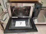 a microwave with a number 7 on it in a kitchen