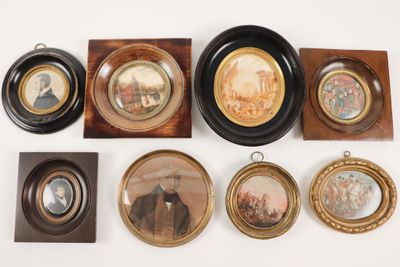 many framed pictures of men and women on the wall