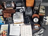 a lot of old cameras and other items on the table