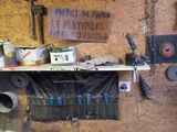 many tools hanging on the wall in this garage