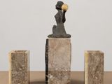a statue of a woman holding a ball in her hand