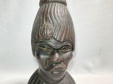 an image of a statue of a woman with a hat on her head
