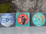 three cds that are sitting next to each other on the ground