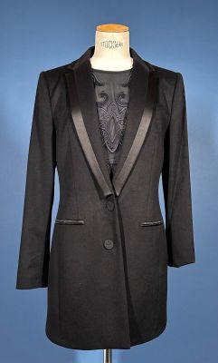 an image of a black tuxedo suit on a mannequin stand