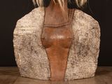 a sculpture of a woman ' s head on a table