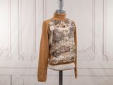 a mannequin on a stand with a sweater on it