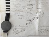 a piece of paper with writing on it next to a black and white clock