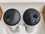 two remote controls sitting on top of a toilet