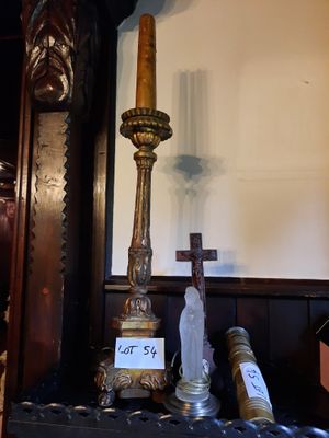 a clock and a candle on a table in a room