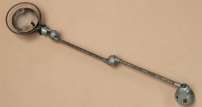 a metal spoon with a handle and a clock on it