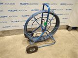 a blue hand truck with a wheel attached to it