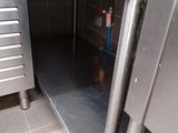 a stainless steel oven with a door open in a kitchen