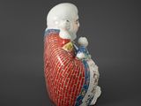 an image of a figurine of a child sitting on a pillow