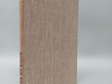 a brown book sitting on top of a white table