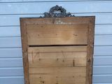 an old wooden chest with a bird nest on top of it