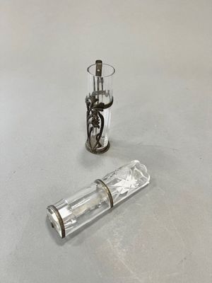 a small glass bottle and a small glass bottle on a table