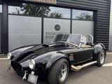 a black sports car parked in front of a building