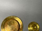a gold plate and a silver plate on a table