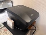 an image of a printer and a calculator on a desk