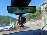 a rear view mirror of a car on the side of the road