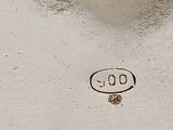 a close up of a silver plate with a clock on it