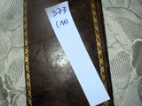 a brown book with a piece of paper on top of it