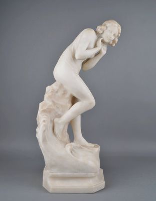 a white marble statue of a man on a rock with his head in his hands
