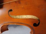 a close up of a violin that is on a table