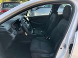the interior of a car with the door open and the driver ' s seat down