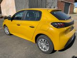 the rear end of a yellow car parked in a parking lot