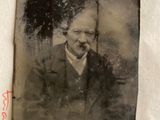 an old photo of a man in a suit and tie on a piece of paper