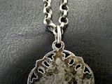 a close up of a necklace on a black surface