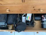a wooden dresser with a bunch of items in it