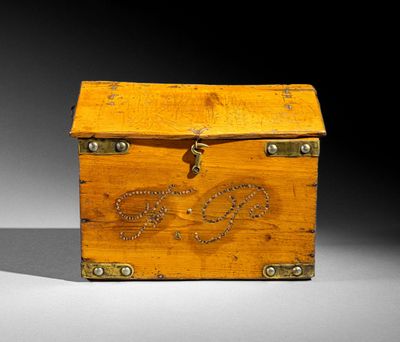 a small wooden box that has a chain on it