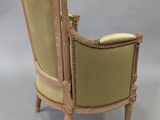 an image of a chair with a beige upholstered back and arms