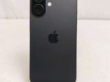 a close up of a black iphone sitting on top of a wooden stand