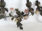 a chandelier that has flowers and leaves on it