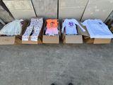 several boxes of clothing are lined up on a sidewalk