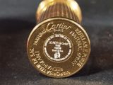 a close up of a gold colored object on a black surface